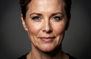 A close-up portrait showing a seamlessly blended face swap result, the inserted face matching the warm studio lighting and skin tones of the original celebrity photo perfectly, with no visible edge artifacts or color mismatches. The result looks indistinguishable from a genuine photograph.